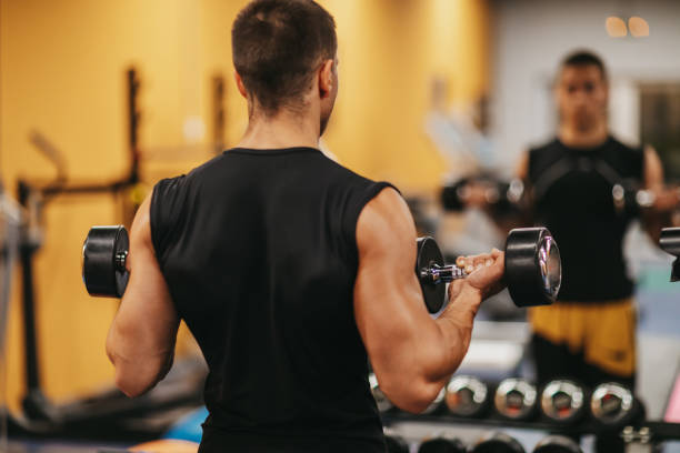 istock Exercising with dumbbells in a gym 1293326935