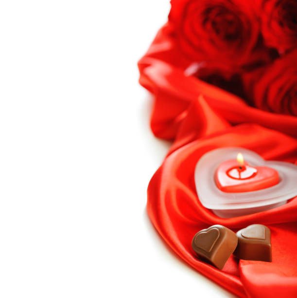 istock red silk and heart shaped candle on white background 1293326955