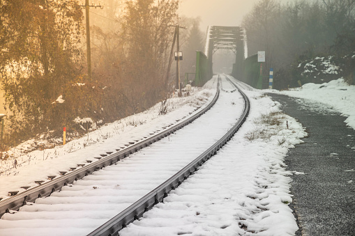 An empty railway track  and the bridge over the Sava river in the background.