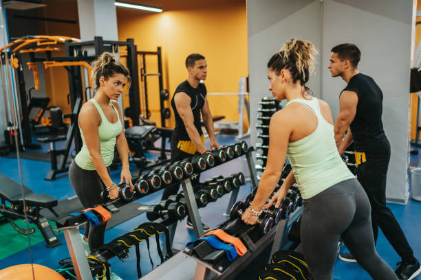 istock Exercising with dumbbells in a gym 1293328541
