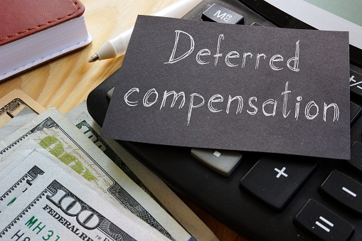 Deferred compensation is shown on a conceptual photo using the text