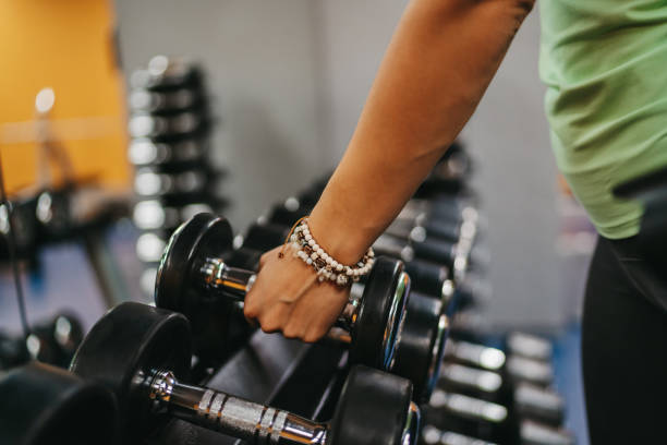 istock Exercising with dumbbells in a gym 1293328795