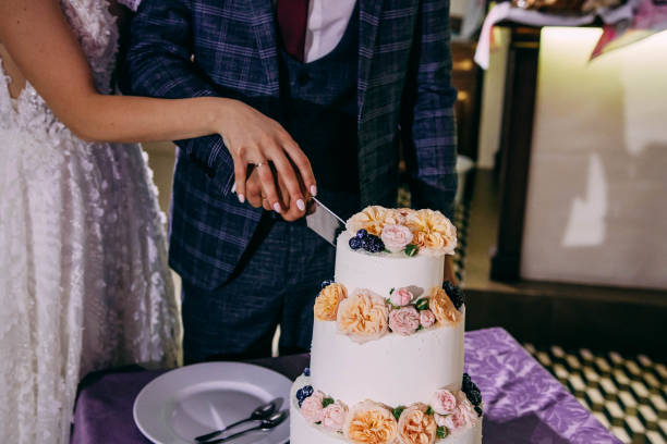 istock Newlyweds cut the cake together 1293330045