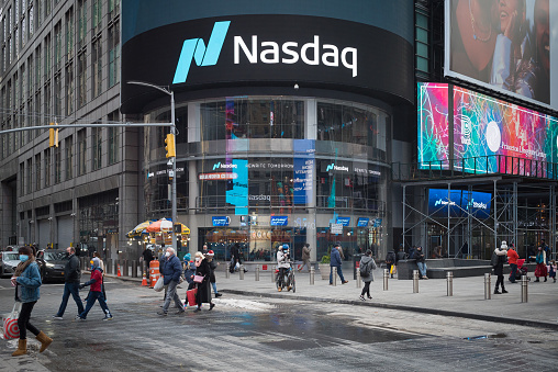 Manhattan, New York. December 23, 2020. People walking in front of Nasdaq market site  located at 4 Times Square.