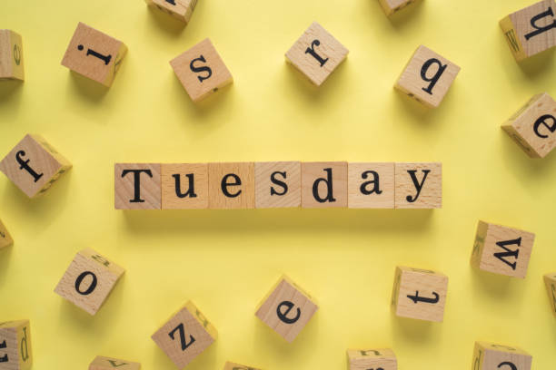 istock Text TUESDAY on wooden cubes with yellow background 1293331146