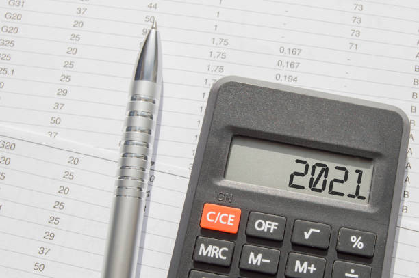 istock 2021 is written on the calculator display, on the desktop with financial documents and a pen. Business concept 1293331148