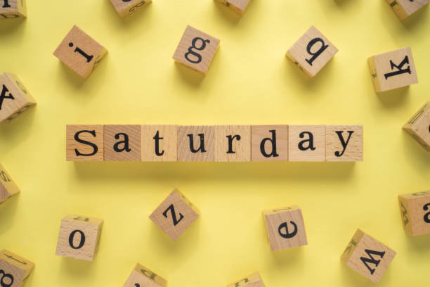 istock Text SATURDAY on wooden cubes with yellow background 1293331151