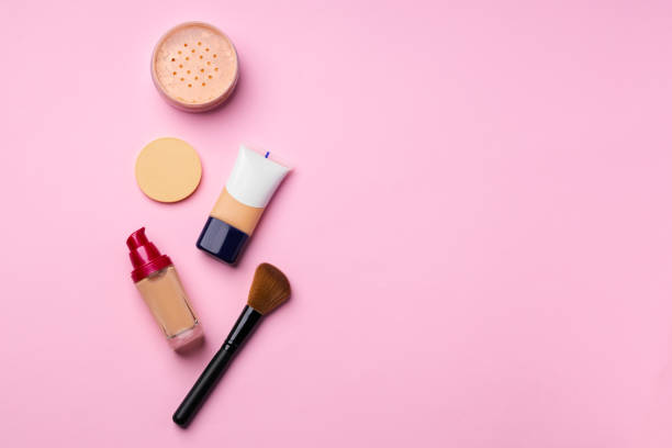 istock Complexion make up products and brush on pink background 1293331220