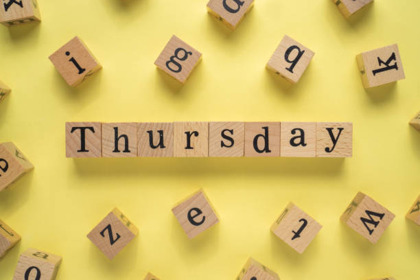 istock Text THURSDAY on wooden cubes with yellow background 1293331225