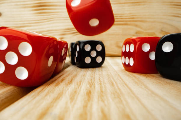 istock Red and black dice cubes on wooden background 1293332294