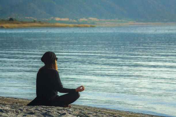 istock Young Woman Practicing Yoga at Lake-Side 1293333104