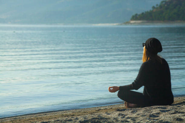 istock Young Woman Practicing Yoga at Lake-Side 1293333127