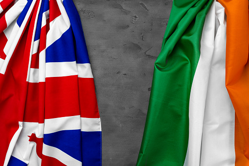 Flags of United Kingdom and Italy on grey background top view