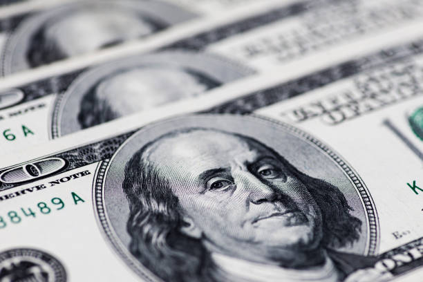 istock A pile of one hundred US dollar bills on a table 1293336618