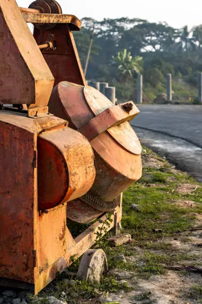 Abandoned Old Rusty Cement Mixer Machine beside the road