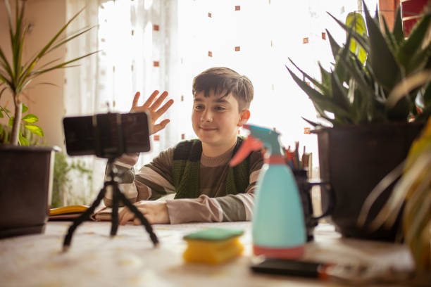 istock School boy is saying hi on video call 1293338208