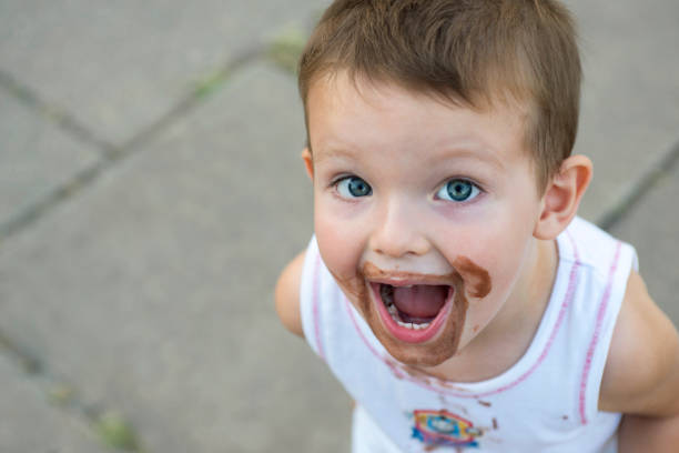 istock boy smeared ice cream. dirty boy 1293338395