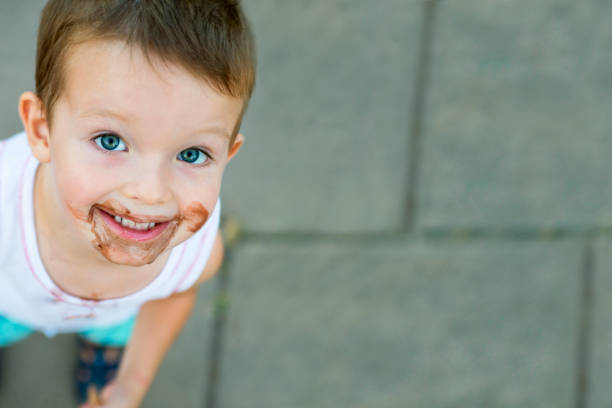 istock boy smeared ice cream. dirty boy 1293338420