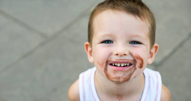 istock boy smeared ice cream. dirty boy 1293338433