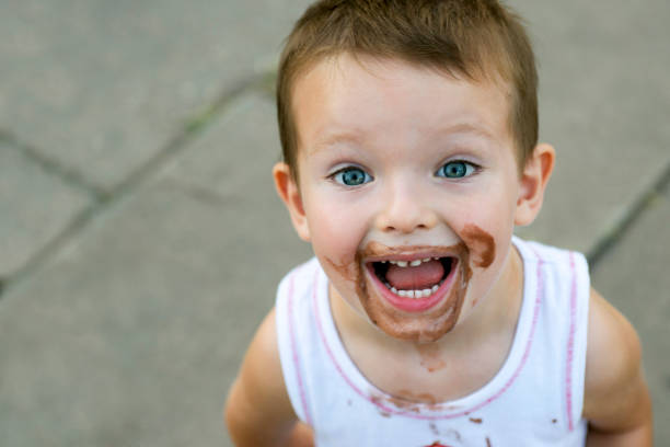 istock boy smeared ice cream. dirty boy 1293338463