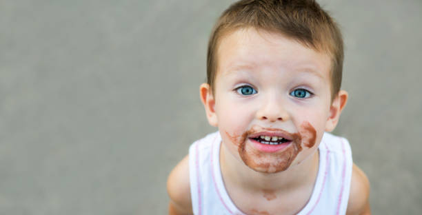 istock boy smeared ice cream. dirty boy 1293338486