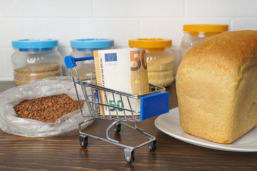 50 Euros in a grocery basket with buckwheat, bread and cereals. Rising food prices and groceries in Europe and other countries. Humanitarian assistance