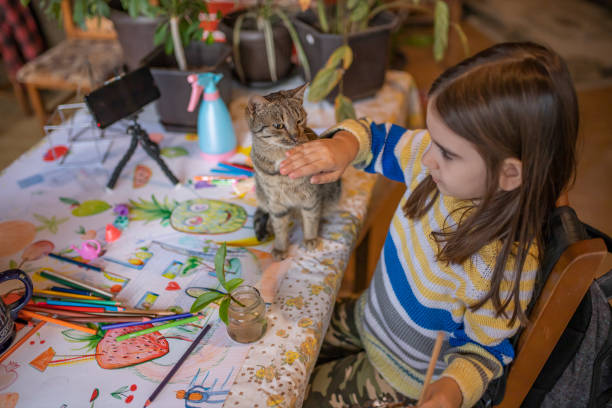 istock Girl sitting at the table and drawing 1293339549