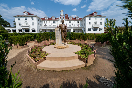 Estes Park, Colorado - September 18, 2020: The Stanley Hotel, with statue and garden in view, on a sunny fall day