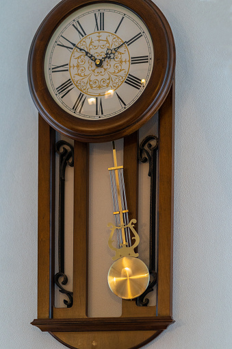 vintage wooden clock with a pendulum.