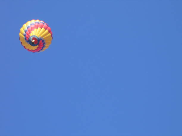 istock Single Object - Multi Colored Hot Air Balloon - In Clear Blue Sky 1293344159