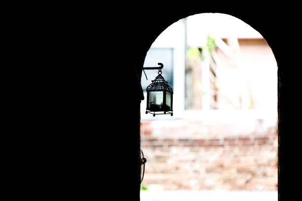 Silhouette of old lantern hanging in small subway, background with copy space, full frame horizontal composition