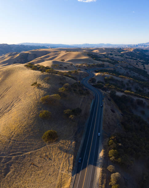 istock Aerial View of Scenic Road Through Rolling Hills 1293353253