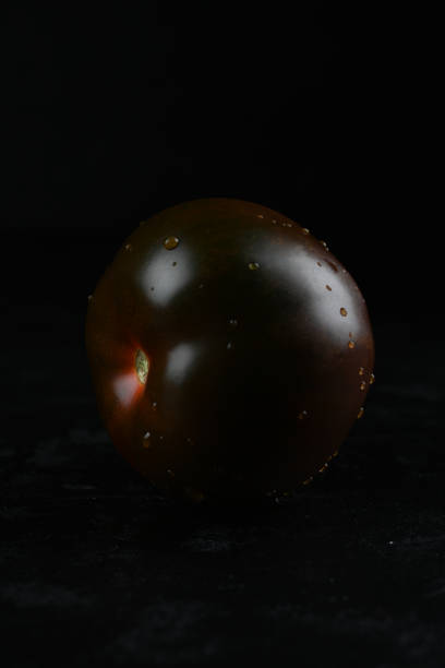 Black tomato - Kumato on the black background.
