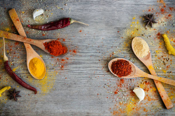 istock Various spices in spoon on grey wooden rustic table, spice background 1293354200