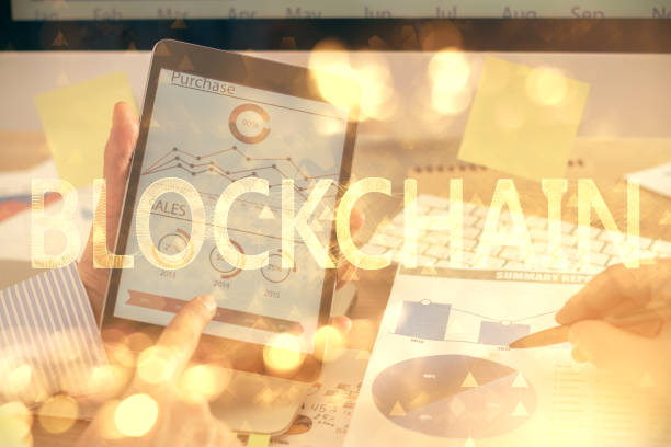 istock Double exposure of man's hands holding and using a phone and crypto currency blockchain theme drawing. 1293356356