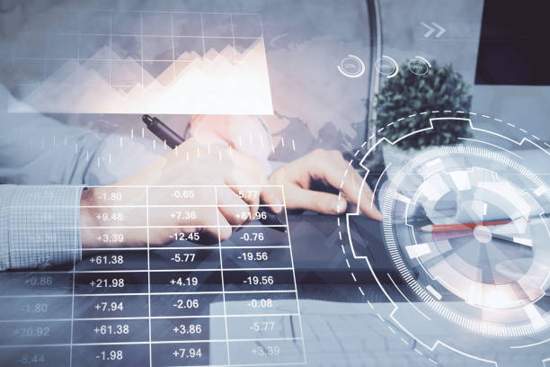 istock Double exposure of man's hands holding and using a phone and financial graph drawing. Analysis concept. 1293356573