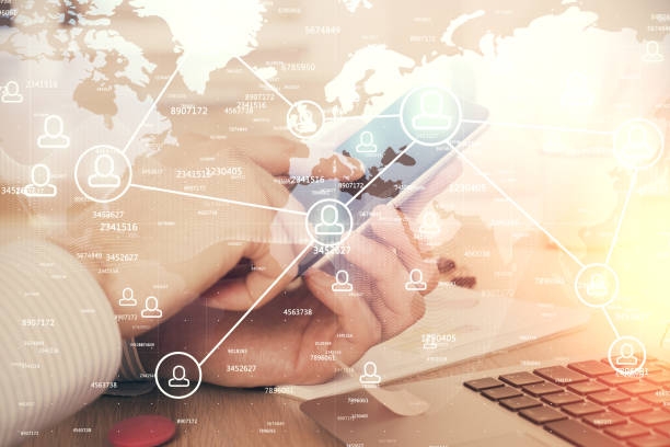 istock Double exposure of man's hands holding and using a phone and social network theme drawing. 1293356586