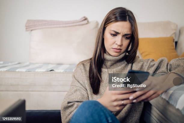 Young Woman Texting On Mobile Phone And Solving Some Problems Stock Photo - Download Image Now