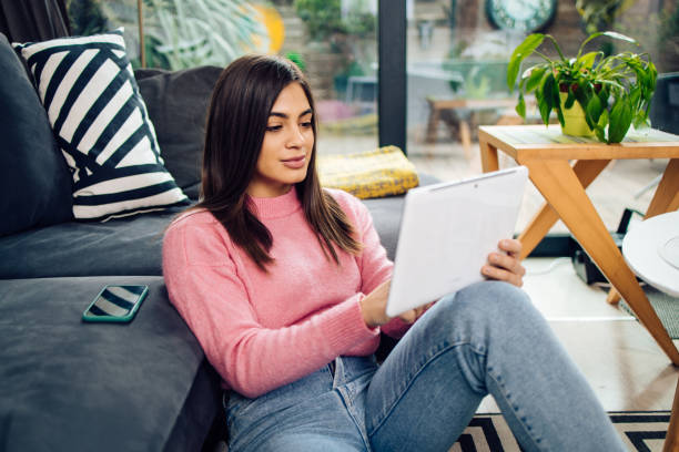 istock Portrait of a beautiful young woman using a digital tablet 1293360193