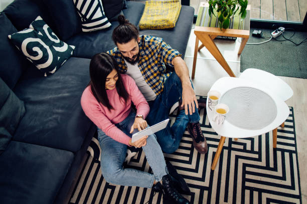 istock Young couple shopping online using a tablet at home 1293360212