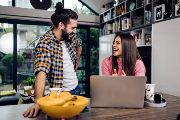 istock Young couple having fun together at their home office 1293360268