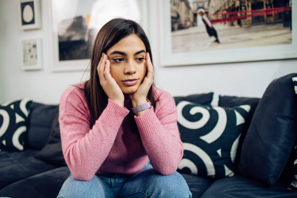 istock Portrait of a girl with some issues, sitting and thinking 1293360329