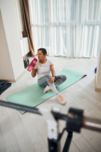 istock Tired athletic lady replenishing the water balance 1293363109