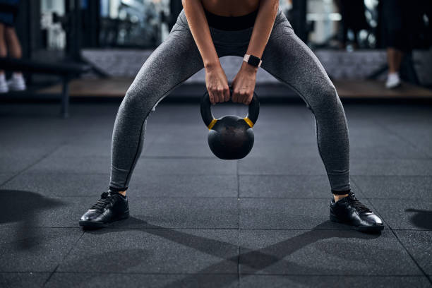 istock Person with kettlebell doing a sumo squat 1293364867