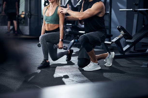 istock Trainer touching a person shoulder to improve her posture 1293366046