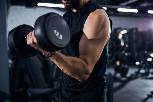 istock Strong male arm lifting a hand weight 1293366073