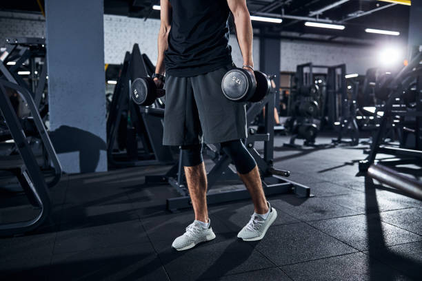 istock Male athlete going somewhere bringing the dumbbells 1293366080