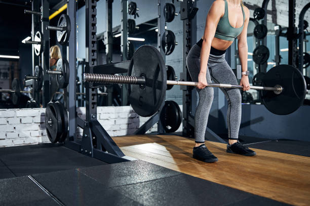 istock Lifting of a barbell to a knee level 1293366090