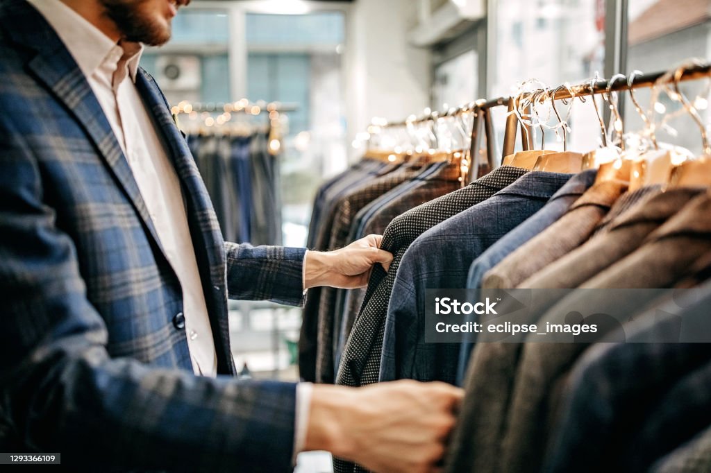 This one match perfect with me Businessman trying suit in store Retail Stock Photo