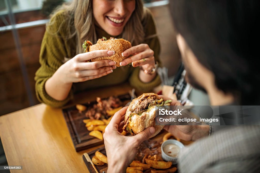 Hamburger for two People elating hamburger Burger Stock Photo